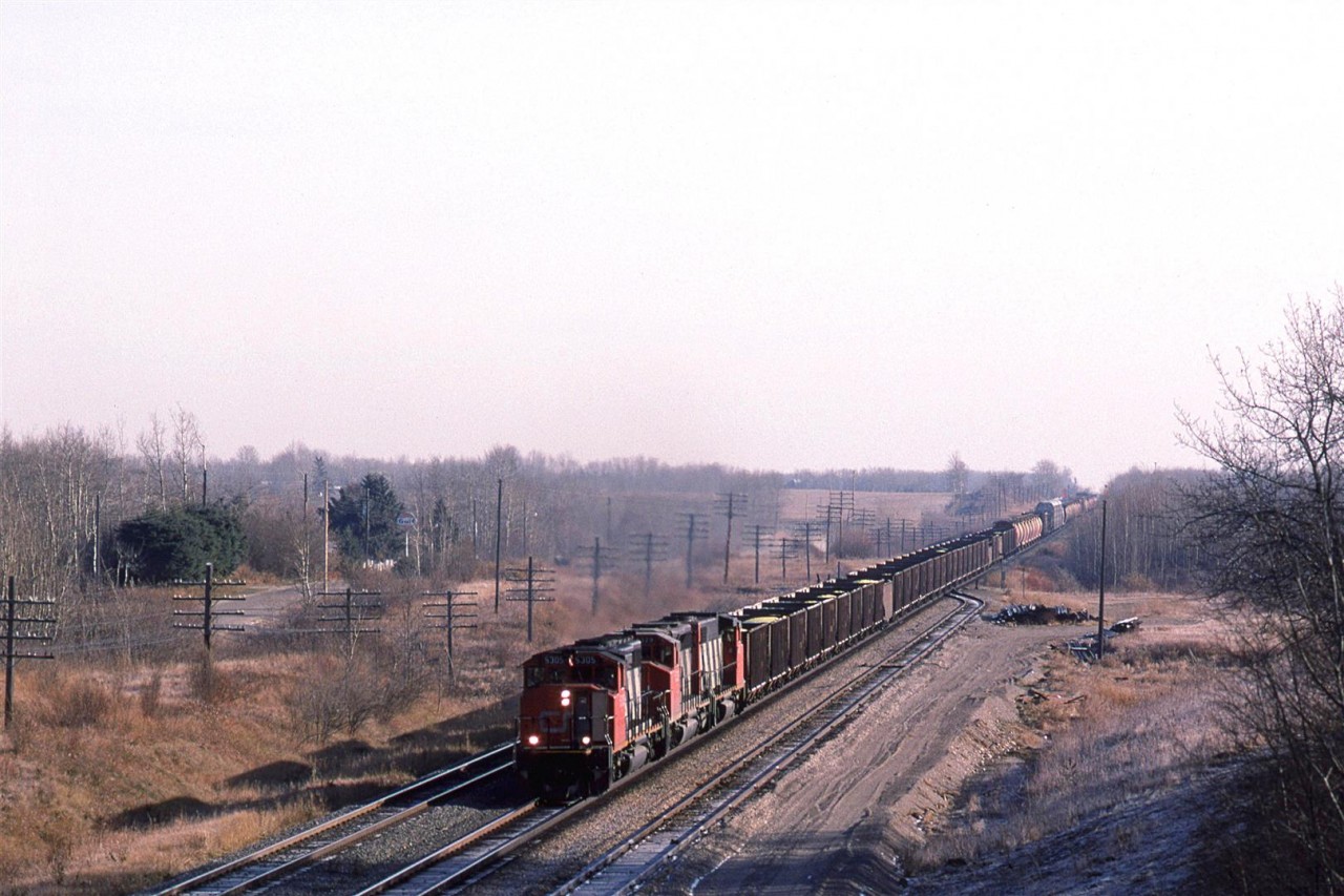 Just because I was able to listen in on the RR conversations, doesn't mean that I would know that train this was. If the crew was broadcast signal indications, they would simply identify themselves as "Extra 5305 West".
This looks like they took all the left over cars in the yard that needed to go west and they put them on this train.
We drove out to Carvel for the first time. It was about an hour's drive from our home. What attracted me to the area were two rather large curves in the Edson Sub mainline (behind me in this scene) that I had seen on a map. There would be several more trips to this location in the future.