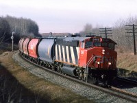 I know that in this day and age, people might think that this is the rear of the train. What, only one engine leading? This was more common than you might think, particularly with empty grain trains. 

Hello Trevor or others in the area; I was wondering if there is a photo eastward from that hill in the background?