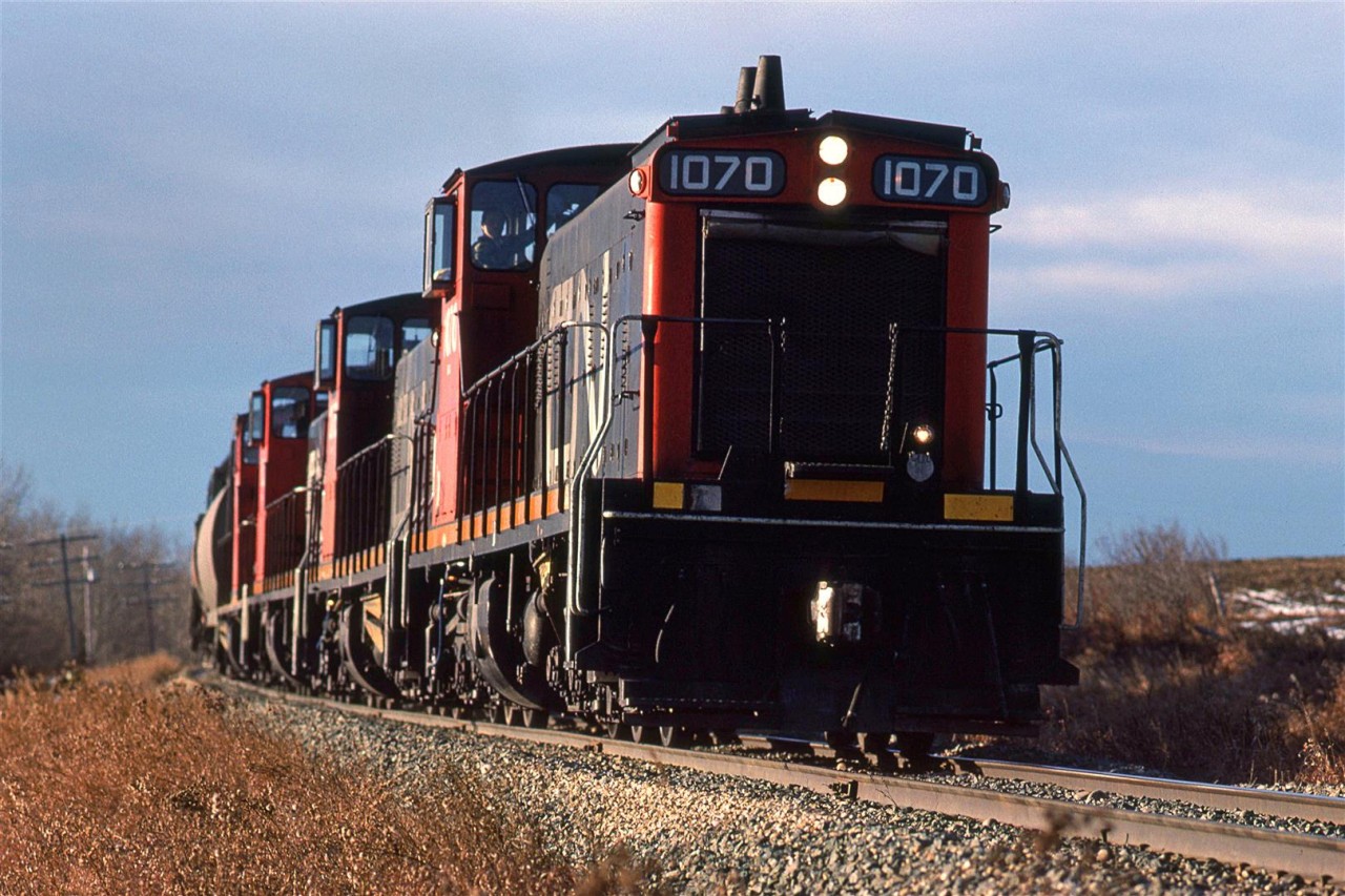 I heard this train come off the shops and convinced my wife that we should chase it up the Westlock Sub. I must have known that it would go up the Legal Sub (off the Westlock Sub at Morinville).
At this time, the Legal (lee-GAL) Sub went all the way to Athabasca. 
Here, it is nearly out of the Sturgeon River Valley at Carbondale. I believe the entire considt was grain cars, all destined for the small elevators on the Legal Sub.