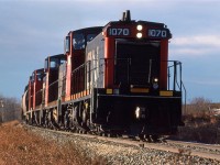 I heard this train come off the shops and convinced my wife that we should chase it up the Westlock Sub. I must have known that it would go up the Legal Sub (off the Westlock Sub at Morinville).At this time, the Legal (lee-GAL) Sub went all the way to Athabasca. Here, it is nearly out of the Sturgeon River Valley at Carbondale. I believe the entire consist was grain cars, all destined for the small elevators on the Legal Sub.