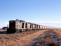 There are problems with chasing a northbound train, in particular, it is difficult to shoot into the sun. At Clyde the tracks made a sweeping curve to the left, which at least gave a slightly more pleasing view of the train. 
In December, in Alberta, however, there is the problem with little daylight altogether. We could not chase this train all the way to Athabasca, but we would get one more shot. 