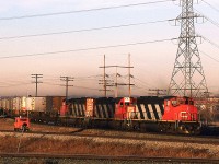 By the low angle warm lighting, one might think that this is an early morning shot, but in Alberta in mid December, it is actually 0930.
A long train to dominantly TOFC snakes out over Bretville Junction, and the crossing of the North Saskatchewan River. The speeder is on the a weird track that that parallels the Wainwright Sub that forms the "top" of the wye on the Camrose Sub (Best seen on the map/satellite photo of the area).