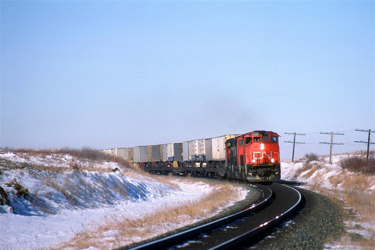 One of the hottest trains at the time, the 214 rounds a curve just east of Tofield. In a moment or two, it would come to a halt for the passing of the westbound "Super Continental".