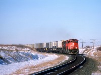 One of the hottest trains at the time, the 214 rounds a curve just east of Tofield. In a moment or two, it would come to a halt for the passing of the westbound "Super Continental".
