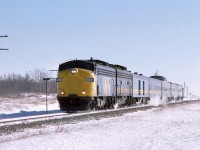 A short westbound "Super Continental"  zips through the rather dull landscape between Tofield and Viking, Alberta. The old covered wagons are living on borrowed time now as new F40PH's will soon force most of the older units into retirement.
