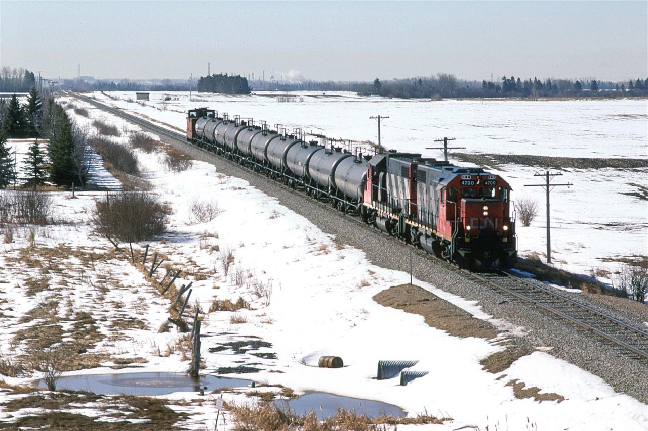 This is a rather distinctive train. It is a delivery of jet fuel to CFB Cold Lake - the railroad calls it Grand Centre. I believe that it was a outbound one day and return the next. 
The steam on the horizon is from the ESSO refinery in east Edmonton.