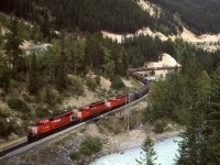 In order to show my railfan acquaintance how one can chase a train from the summit of Kicking Horse Pass all the way to Golden - the area covered by his planned guide, we decided to chase this train. The next several photos were all taken from roadside locations. This was our eighth photo location, from a now removed bridge that hosted a muck more dangerous routing of the Trans Canada Highway through this area. I don't believe that this shot is reproducible now, but the old highway is still there and a better shot may exist now that the bridge is gone. I have not see any shots from the new bridge. I suspect that the view upriver is not all that spectacular though.