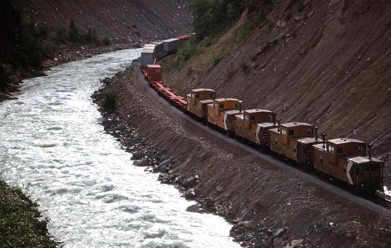 In order to show my railfan acquaintance how one can chase a train from the summit of Kicking Horse Pass all the way to Golden - the area covered by his planned guide, we decided to chase this train. The next several photos were all taken from roadside locations. This was our ninth shot, taken at pretty much the same spot as the eighth. As I said earlier, there was just about everything on this train, including 5 vans. We did not give chase into Golden as the photo ops are few, and are dangerous to access. Stopping along that stretch of road was not a good idea, nor was having to cross the road to get the view. There are a few places where photos may be had, but they are best left for eastbounds.