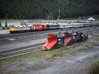 The lead units of the westbound "Canadian" block the depot at Field. Snow removal equipment waits for another season. 
The blue roofed building in the background is the Yoho National Park Visitor Center.