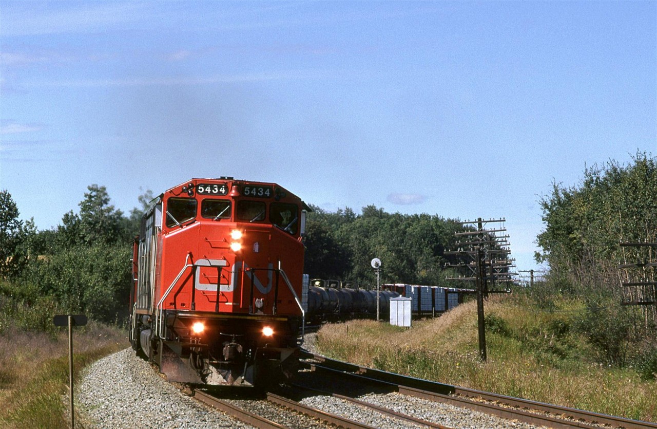 My best guess is that this is train 358 or 360 from Prince George, BC because of the forestry products on the front end. I am a little confused about the tank cars though. And my next picture shows the tail end of a train (I am not 100% certain that it is the same train, however) with grain hoppers, a very uncharacteristic feature of these two trains.