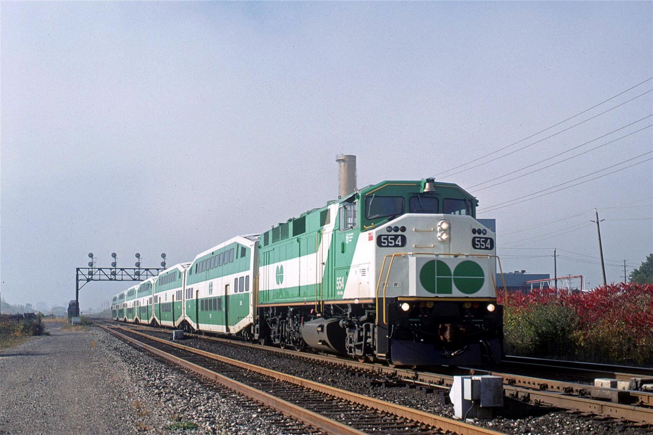 This morning started out dark and foggy, but that soon changed. 
An eastbound GO train zips by the Ford plant adjacent to the CN yard. I believe that this is a Sunday morning, which explains the short train on the Lakeshore route.
