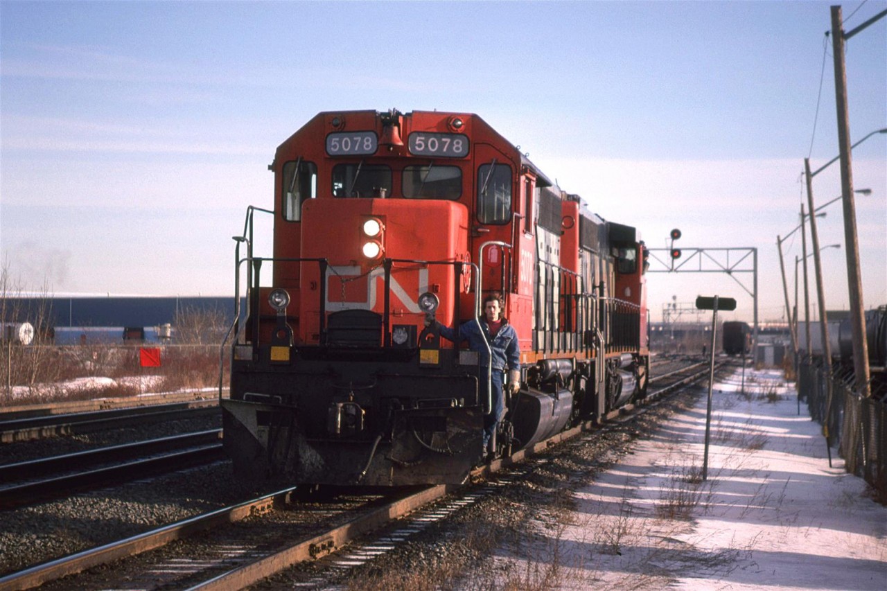 The CN employee does not look too enthused with me taking this picture. You can be certain that I did not look like a supervisor trying to collect evidence (I probably had my bicycle helmet on).

I believe this this is the power that has come off #354 as it arrived in Edmonton. It is now on the Calder bypass track, which it will use to go to the shops located at the west end of the yard.