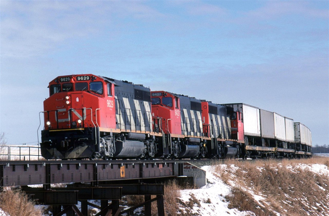 TOFC was still king in intermodal in early 1991 in Canada. This is only of their "hot" train on the eastern outskirts of Edmonton. It must been during the winter thaw since I doubt that I would have bicycled (or been able to bicycle) out there it it were -20 degrees or colder outside.