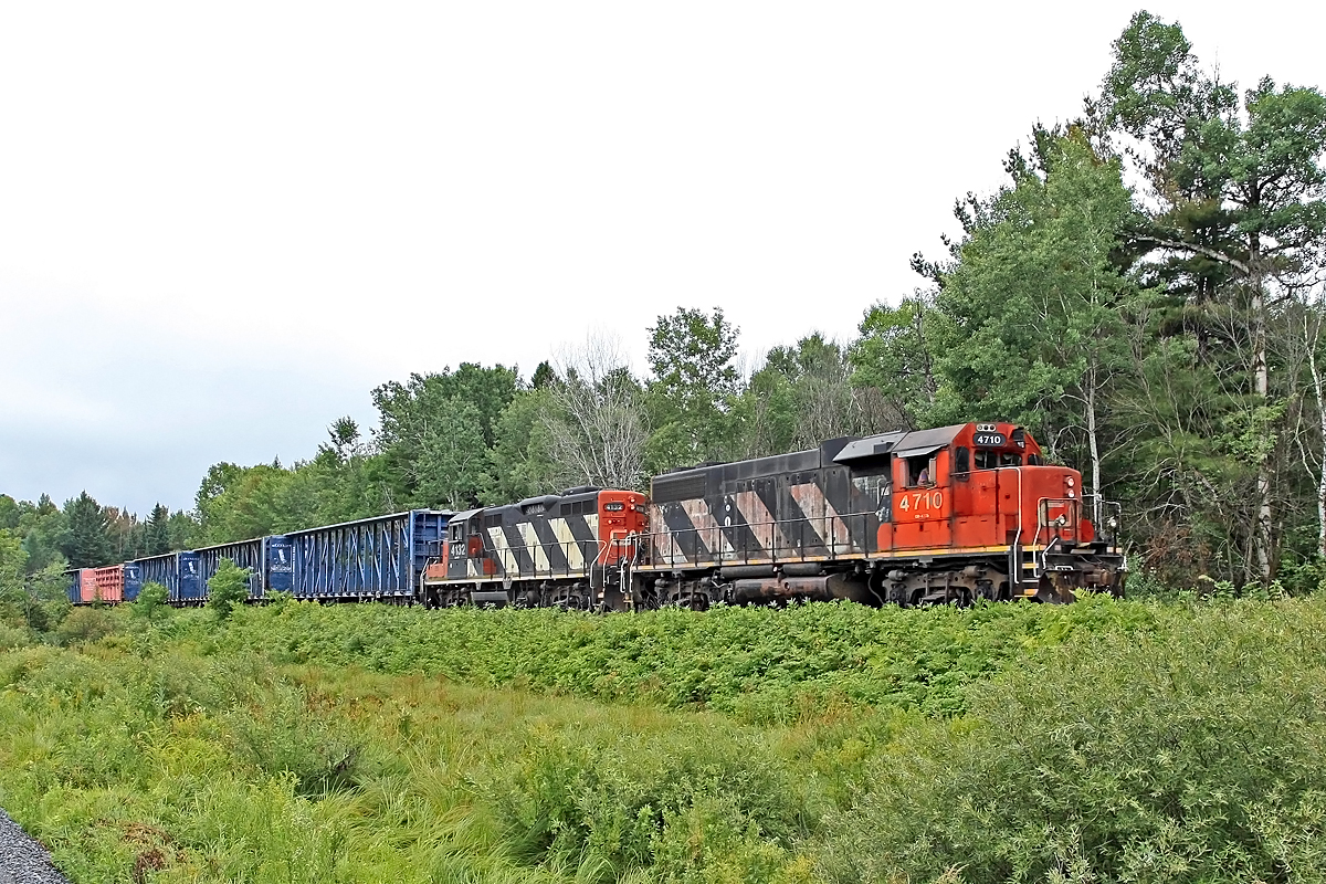 Scraping the bottom of the power pool? Admittedly nothing special at all about this shot save for the fact that CN sent today's 451 on its way from Mac Yard up to North Bay with only a GP38-2 and a GP9 with 65 cars in tow. The train consisted of mostly center-beams, box cars, coil gons and chemical tanks. The center-beams were obviously empty as I assume were the coil gons and box cars (saw at least one with the doors open). Can't guess as to the tanks but regardless it's no surprise they elected to keep 4132 in consist instead of dropping it off in Huntsville like they would normally do. Crew gave their rest notice @ 11:09 while they were passing Mile 125 and it was reported passing Mile 154 @ 12:20, so I'm kind of wondering if they got a fresh crew at Huntsville (Mile 146) or were trying to push it further north.