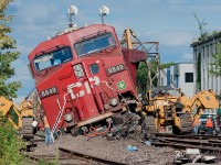The aftermath of this mornings sideswipe at Howland between light power CP 235 and the tail end of CP 118 (now gone), Hulcher crews are on scene ready to lift the power back on the rails. Luckily no injuries.  