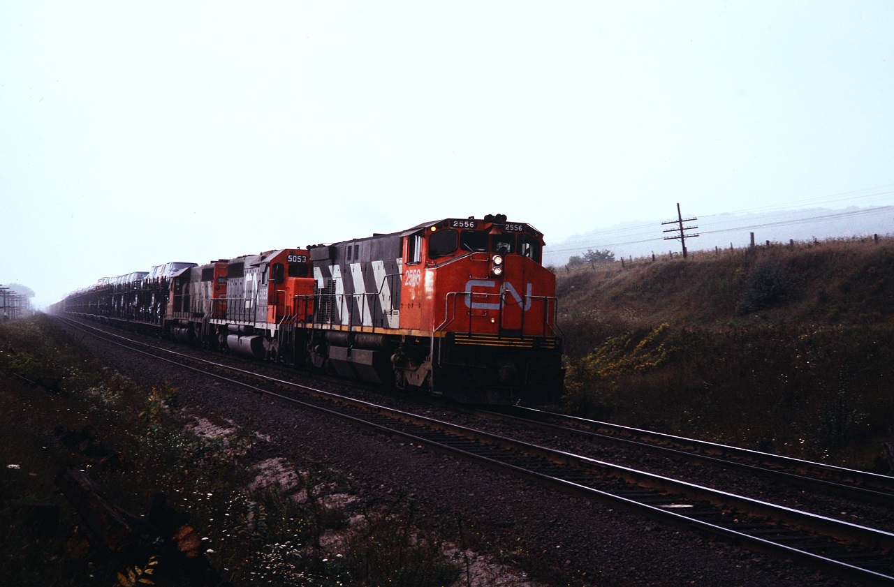 In the days before welded rail and ditch lights, M-420 2556 leads a pair of SD-40's east approaching Port Hope. The M-420's would later be lightened and renumbered to the 3500 series. Photo by my brother.