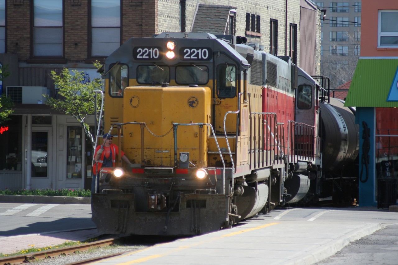 On a beautiful spring morning, Goderich-Exeter Railway (GEXR) train X580 is seen crossing King Street in downtown Waterloo, Ontario on Saturday, ‎May ‎5, ‎2007. Units LLPX GP38AC 2210 and GEXR GP38AC 3835 would have easy work ahead as they hauled three tankers to Elmira on the Waterloo Spur.