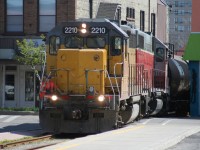 On a beautiful spring morning, Goderich-Exeter Railway (GEXR) train X580 is seen crossing King Street in downtown Waterloo, Ontario on Saturday, ‎May ‎5, ‎2007. Units LLPX GP38AC 2210 and GEXR GP38AC 3835 would have easy work ahead as they hauled three tankers to Elmira on the Waterloo Spur. 