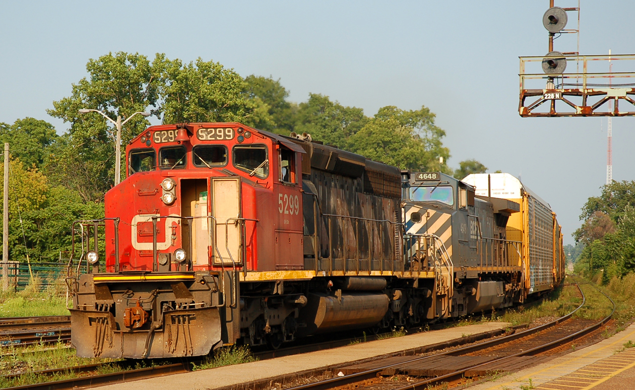 CN 5299 - BCOL 4648 lead CN M39931 16 through Brantford on a sunny august evening. I remember this being a fairly busy one with 5 or 6 trains within an hour