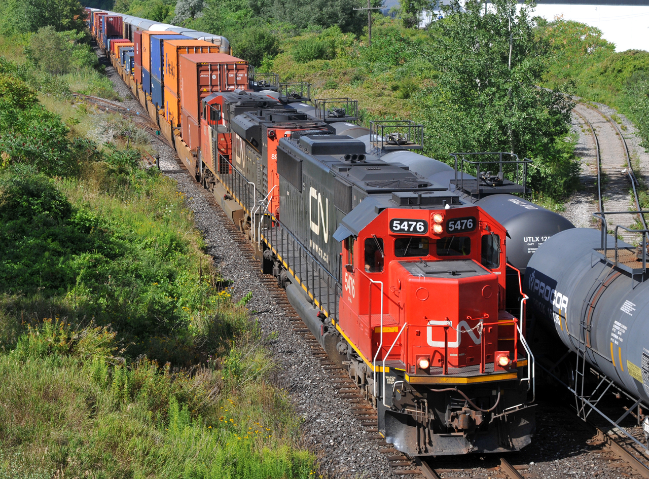 CN SD60 5476 and SD70M-2 8958 crawl past Wayne Gretzky Parkway as they slowly get back underway with Q14891 13. I believe they had gone into Emergency around Hardy for several minutes beforehand