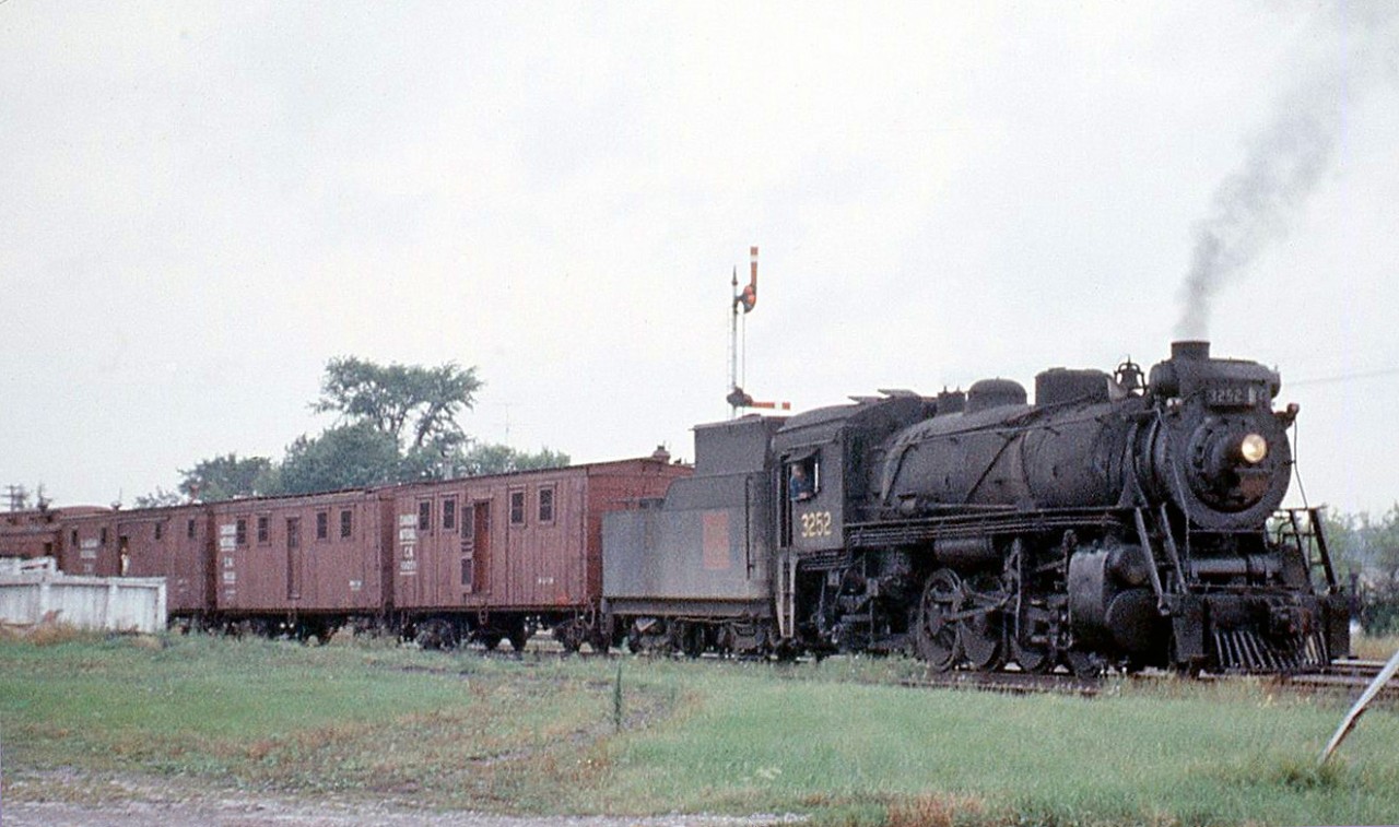 A CN work extra, with S1b-class Mikado 3252 (built by Canadian Government Railways in 1917, scrapped November 1959) is pictured at Lorneville Junction in August 1958.

Lorneville was the junction point between CN's Coboconk Sub (Blackwater to Coboconk) and their Midland Sub (Lindsay to Midland). Much of the old Coboconk Sub (and the eastern portion of the Midland Sub) were abandoned in the mid-1960's, leaving Lorneville without any rail service less than a decade after this photo was taken.