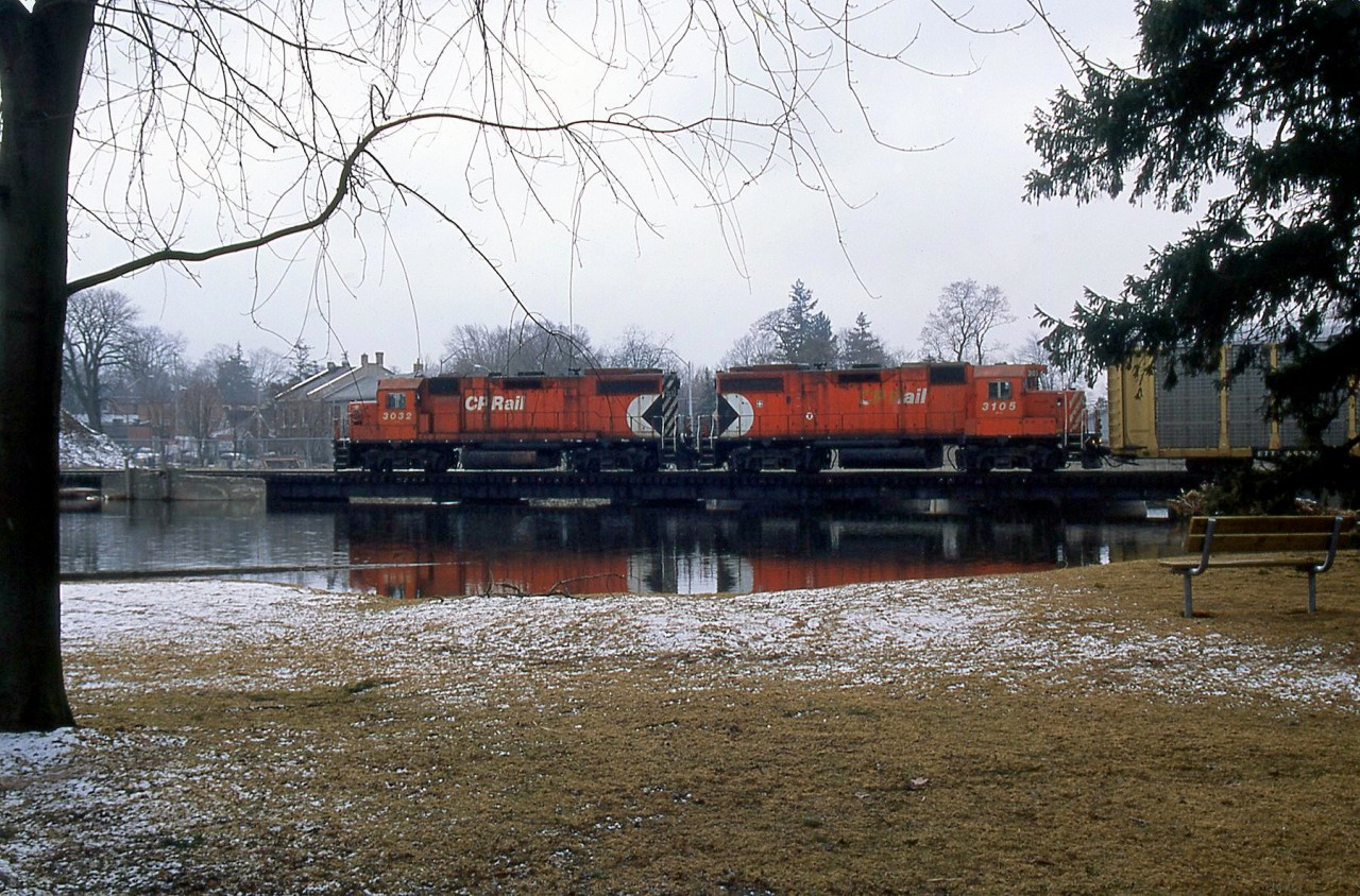 CP's Toyota switching job is returning through Preston, with GP38-2's 3038 and 3105 in charge, shown crossing the Speed River bridge on the old Grand River Railway line.

A view crossing the bridge nearly 50 years before: http://www.railpictures.ca/?attachment_id=22965