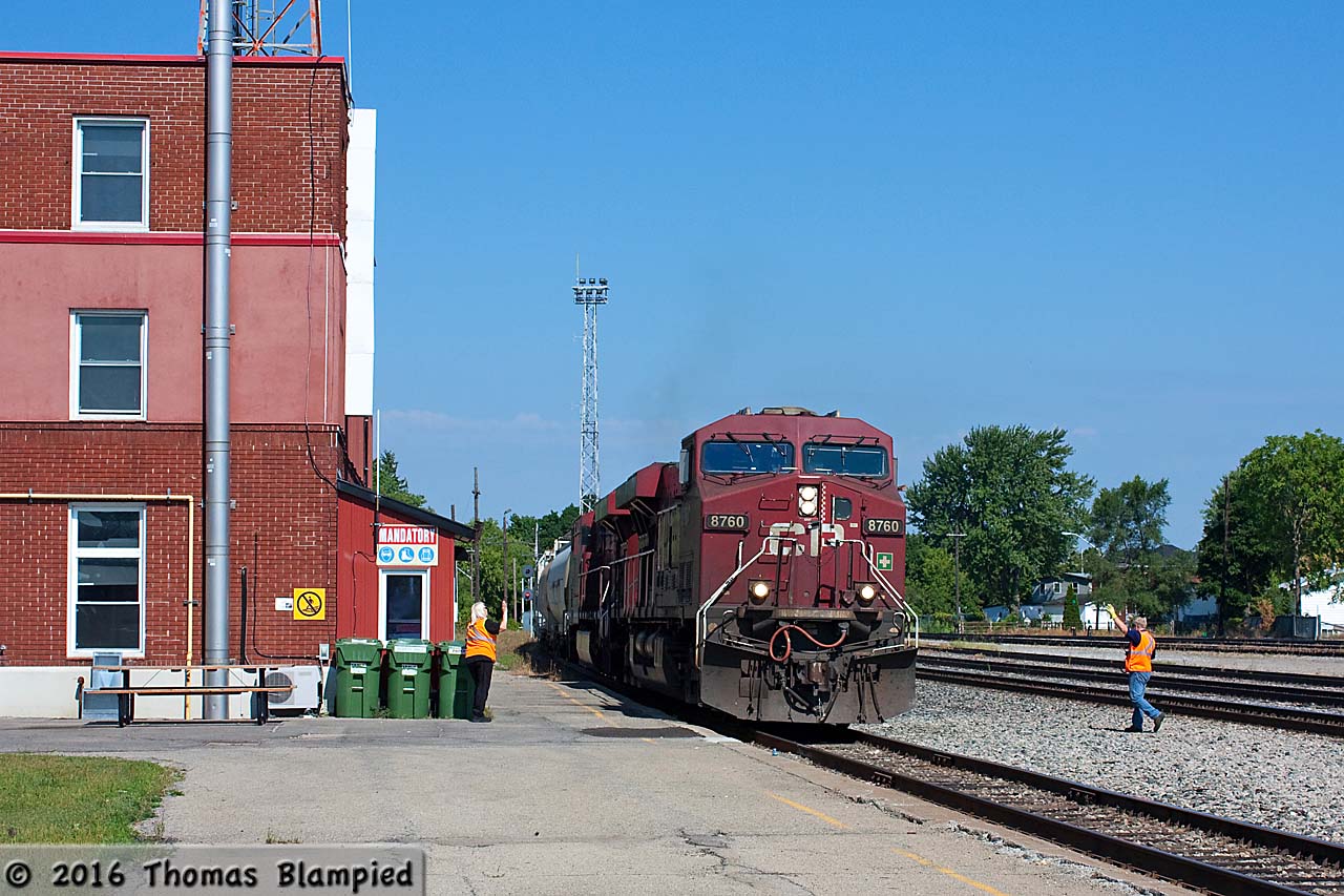 Crew perform a roll-by inspection as CP 8760 and 8723 lead a westbound train past the Smiths Falls crew office.