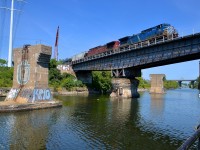 <b>Over a locked swing bridge.</b> CEFX 1002 & CP 8501 lead loaded ethanol train CP 650 over the Lachine Canal. They are passing over what is a swing bridge that is now locked in place, as commercial boat traffic has not used this portion of the canal since the 1970's.