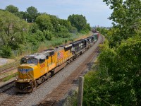 <b>Flying the flag, in Canada.</b> Adding some colour, as well as American patriotism to the usual all-NS lashups on CN 528/529, SD70M UP 3806 with the UP wings on the nose and the American flag on the hood leads CN 529 through Montreal West with a short train. Trailing are NS 6983 & NS 9535.