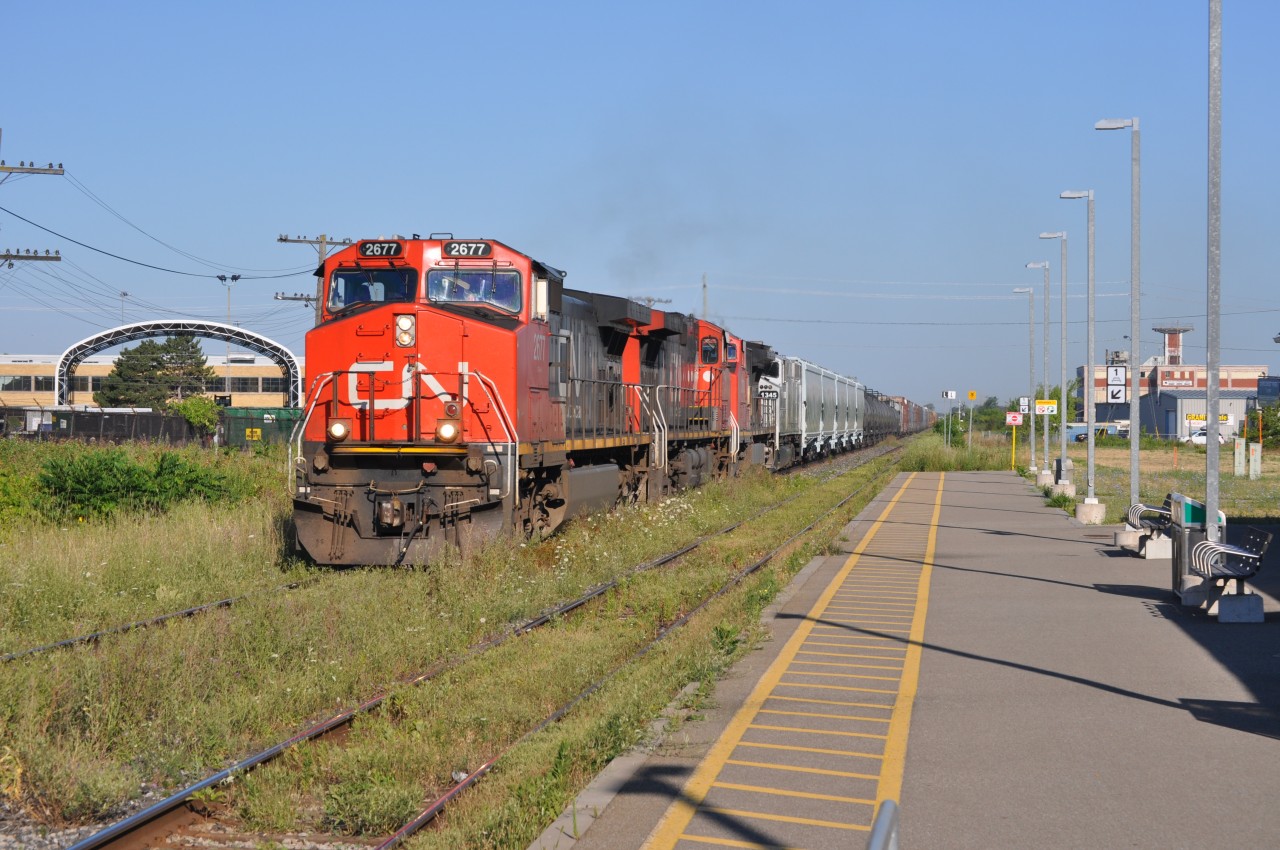 The second train of the morning at the station seemed like any usual CN 421, until after I took this picture. As soon as I lifted the camera off my face, I realized that the 4th unit wasn't a white car, it was actually an engine! I tried to take a going away shot of it, but the early morning back lighting played a big factor in that photo. The 4th unit was AMT 1345, probably going somewhere to get repaired or painted. It was quite a surprise for sure. I said about two minutes before 421 went by "let's pray for something cool"...guess I got my wish.