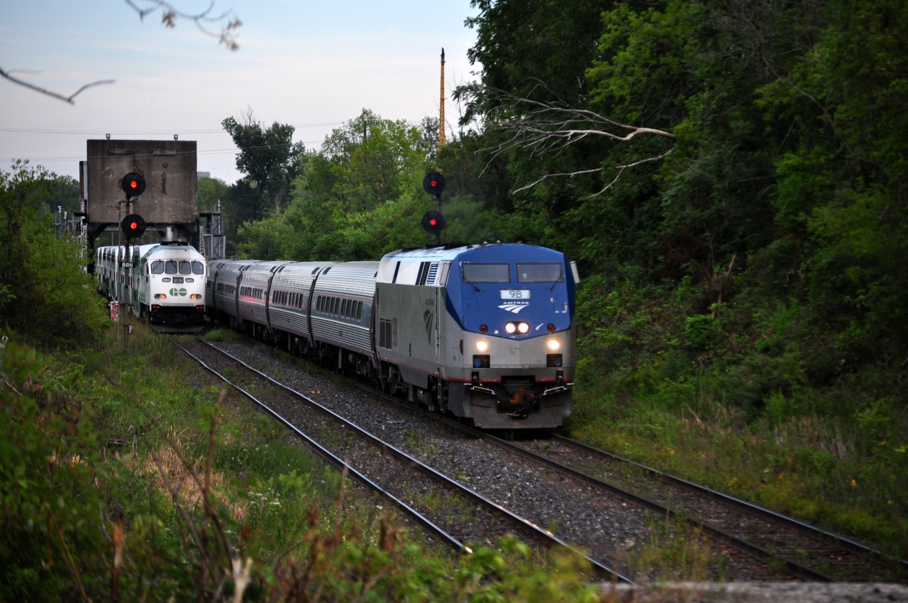 I adventured down here a few days prior, and noticed that some weeds beside the North track had been cut down, so knowing that, I took advantage of some open areas today. But not all areas were brush free. I ended up waist deep in thorns trying to get over to the side, and pulled a couple muscles hoping up onto the platform. Overall, it was worth it, as I caught a meet between one of the weekend GO Trains, and Amtrak 98, who ironically was led by unit 98. As I clean all the cuts and upload this photo, I ask myself. Was it worth it? My answer? Totally.