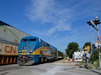 <b>A 'paddle marker' in the coupler.</b> VIA 911 brings up the rear of VIA 633 as it passes CN 120, both crossing the St-Ambroise crossing in St-Henri. VIA 911 has what has been dubbed the 'paddle marker' in its coupler. This is seen at the end of all VIA Rail trains going back a few years now.