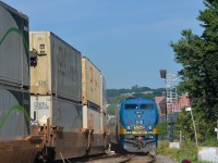 <b>VIA 633 by stacks and a new signal.</b> VIA 911 brings up the rear of VIA 633 as it passes CN 120, both are passing MP 3 of CN's Montreal Sub. At right is a new set of signals, not yet activated.