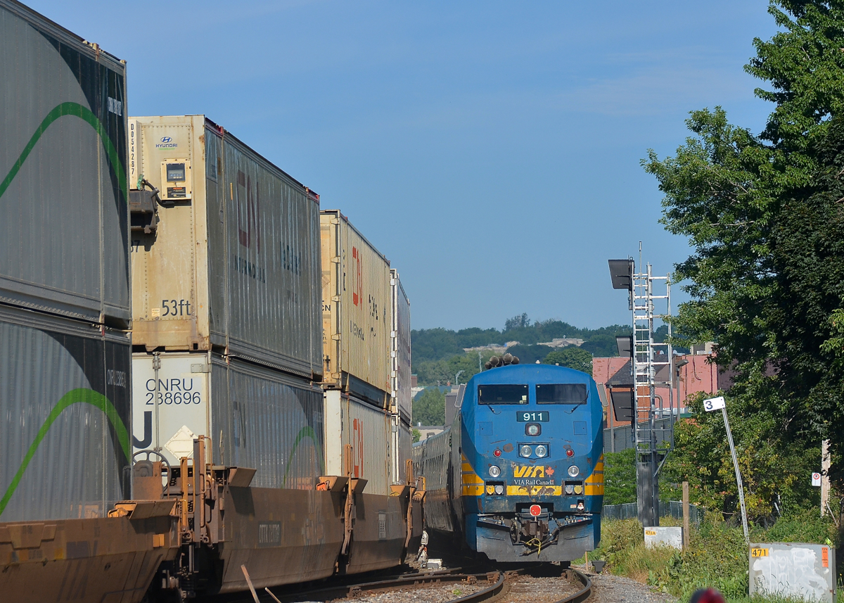 VIA 633 by stacks and a new signal. VIA 911 brings up the rear of VIA 633 as it passes CN 120, both are passing MP 3 of CN's Montreal Sub. At right is a new set of signals, not yet activated.
