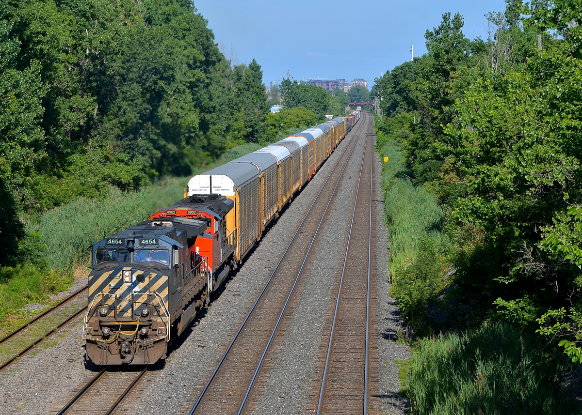A BCOL leader after a 2 hour wait. I waited nearly 2 hours to shoot CN 401 with BCOL 4654 as the leader and CN 8902 trailing, seen here approaching Taschereau Yard in Lachine. It arrived here much later than I expected as it set off CN 4793 and 15 cars at Southwark Yard, a rarity for this train which is a straight shot from Joffre Yard to Taschereau Yard most of the time.