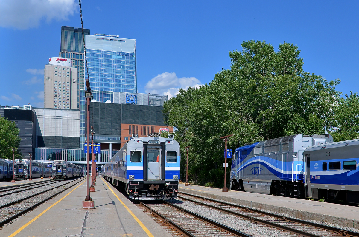 Beginning of the afternoon rush hour. It's the beginning of the afternoon rush our as AMT 1326 at right brings a Candiac-line deadhead train into Lucien L'Allier station. Another Candiac train (AMT 87) is in the middle led by cab car AMT 701 and it will depart in about 15 minutes.