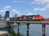 Three GP9's (CN 7075, CN 7256 & CN 7229) lead a short transfer out of the Port of Montreal as they cross the Lachine Canal today at lunchtime, seconds after the sun came out. While this job generally has two GP9's, three of them is very rare. 