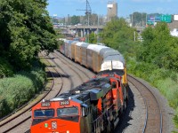 <b>Autoracks at the head end, as always.</b> CN 401 (Joffre Yard to Taschereau Yard) has autoracks at the head end 99% of the time and today's example was no exception as it rounds a curve in Montreal West, only a few miles away from terminating. Powering this long train (566 axles) are CN 2923, CN 8852 & CN 2141.
