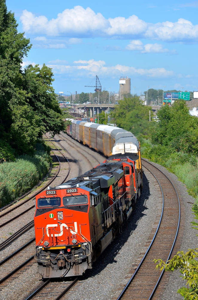 Autoracks at the head end, as always. CN 401 (Joffre Yard to Taschereau Yard) has autoracks at the head end 99% of the time and today's example was no exception as it rounds a curve in Montreal West, only a few miles away from terminating. Powering this long train (566 axles) are CN 2923, CN 8852 & CN 2141.