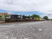 NS 6747, NS 8318 & heritage unit NS 1069 lead CN 529 through the St-Henri neighbourhood of Montreal.