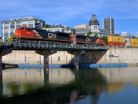 <b>Ex-demo leading.</b> CN 8100 is one of only four SD70ACe's on the CN roster and was built as EMDX 1206, an EMD demo. It was repainted in CN colours a bit over a year ago, here it is seen leading CN 149 as it crosses the Lachine Canal in the Port of Montreal. Trailing is CN 2818.