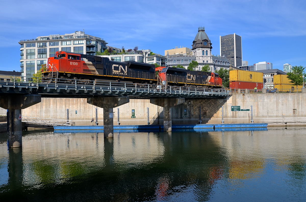 Ex-demo leading. CN 8100 is one of only four SD70ACe's on the CN roster and was built as EMDX 1206, an EMD demo. It was repainted in CN colours a bit over a year ago, here it is seen leading CN 149 as it crosses the Lachine Canal in the Port of Montreal. Trailing is CN 2818.