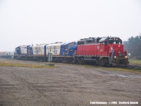On a very miserable, yet warm but foggy November day, I visited the Stratford station. To my luck, I actually saw two GEXR trains this day. However, being more into railway stations back then, I did not get a lot of decent photos of the trains. However, out of the select few, I am submitting the first of two.....(note the engineer and conductor look on as they get ready to depart Stratford, and in their tow is now OSR 1401 in full RailLink regatta as well as sister 1400, with 4001 in tow.
<br>
<br>
Anybody have any information on 1400 or 4001?