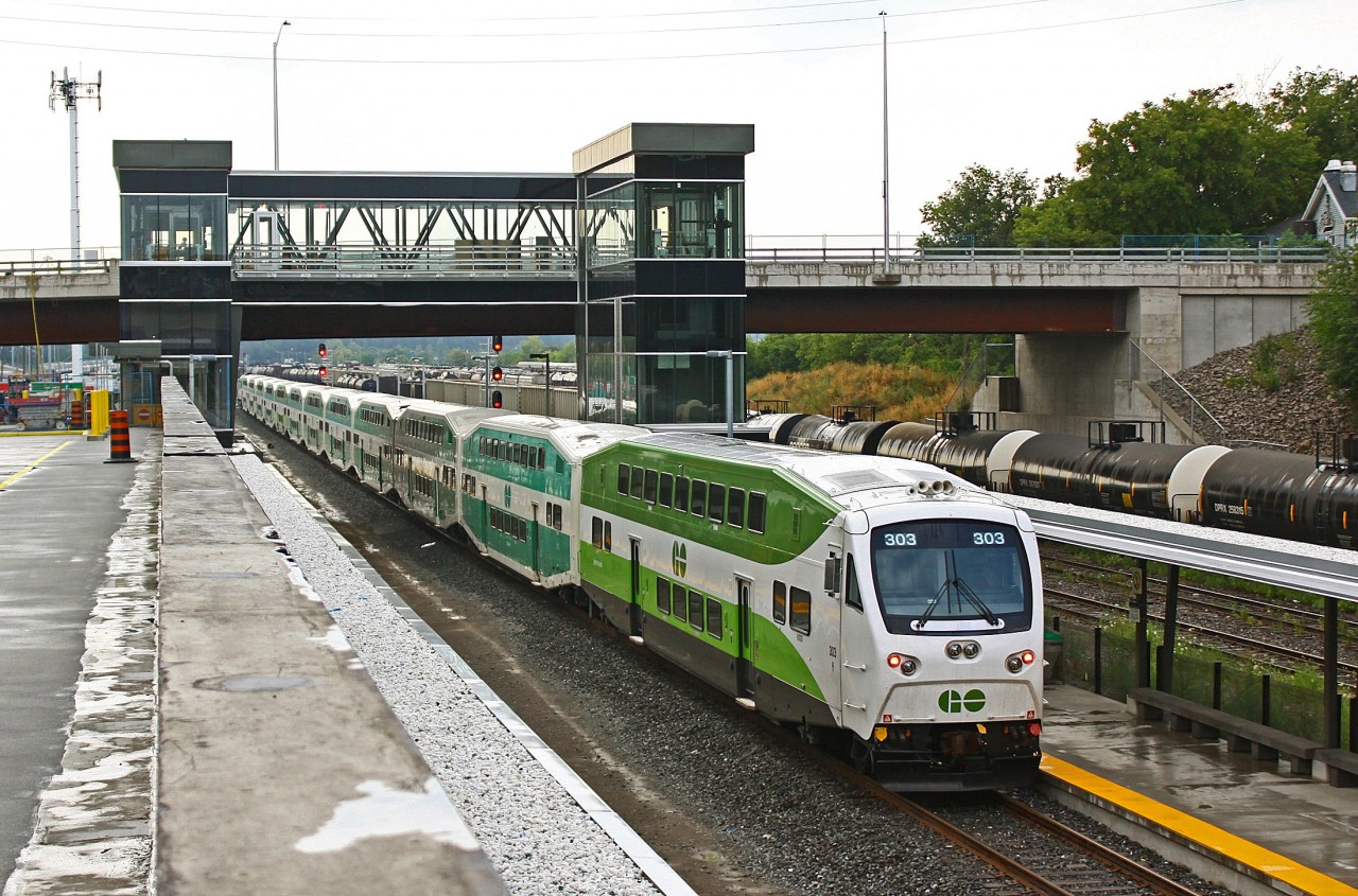 Go cab car 303, the only car in the new paint design in this consist, brings up the rear of the departing 5:15 at West Harbour. Above the train the west end station bridge stands, still under construction (along with most of the station). In the background are some tank cars of interest under reporting mark DPRX, seen with the very noticeable white tank heads. DPRX stands for Deep Rock Refining Company, who has these cars to haul crude oil. The cars seen in this photo though are in asphalt service. A sign of the times. With the recession hitting the oil industry car demands are way down. So companies are either storing cars or leasing them out for use with different commodities, like we see here. Taken from the Harbour West parking lot. (Thanks for the info Peter)