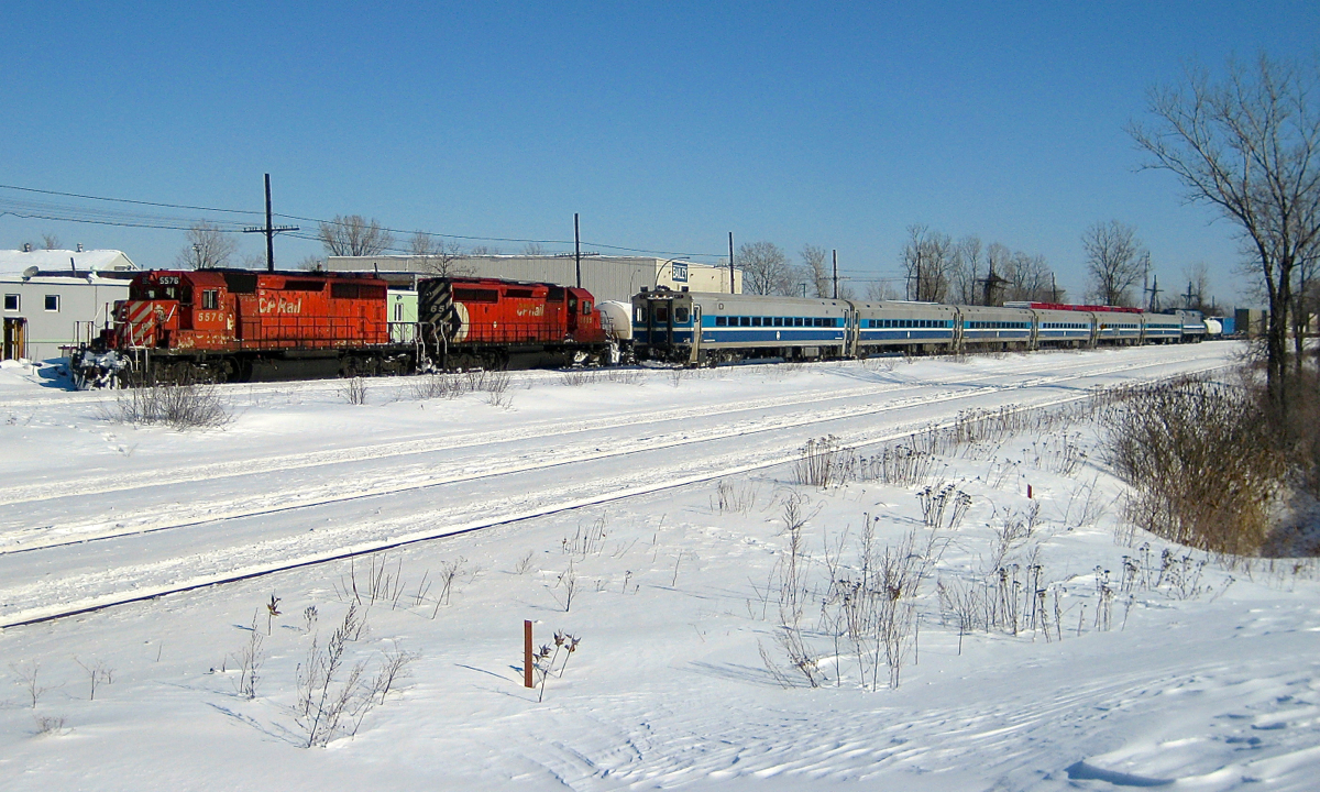 Approaching a pair of SD40-2's. In the winter of 2008 a CP westbound led by two venerable SD40-2's (CP 5576 & CP 5865) cools its heels while an AMT westbound passes with cab car AMT 706 leading and AMT 400 pushing. These AMT Comet II cars would be rebuilt and repainted a few years later. CP 5576 was retired later that year whereas CP 5865 was still on CP's roster as of the start of 2016.