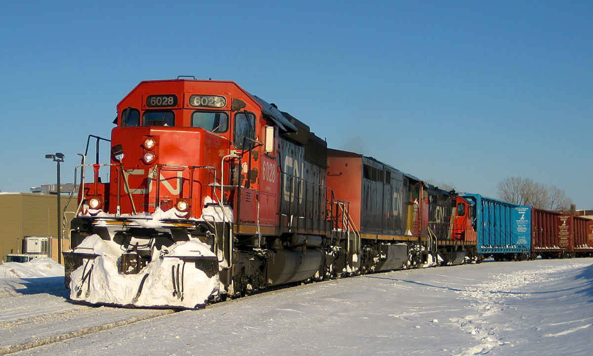 During the winter of 2008 a westbound is rounding a curve in the St-Henri neighbourhood of Montreal with a lashup impossible to replicate today out on the road (as the 6000's are now in hump service): SD40U CN 6028, Dash8-40CM CN 2447 & GP9 CN 7075. The train may be CN 323, returning from St. Albans, VT.