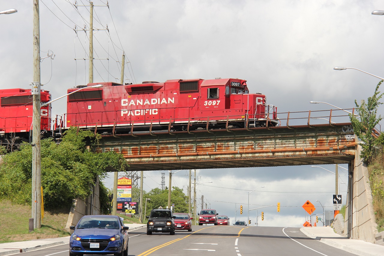 The CP Waterloo Sub was busy this Sunday afternoon. I'm not great with train symbols (unless they're explicitly spoken over the scanner) but since I can see train movements on the Waterloo Sub from where I live, this train doesn't seem to come across very often. In the yard (GEXR/CP) interchange already is what I believe to be the Hagey Job with two GP20 ECOs or whatever they're called. This particular power set had three locomotives, including two classic GP38-2s (3097, 3042), which is becoming increasingly rare these days. I believe this one is the Wolverton Turn, though I'm not positive on that. It came in from Cambridge with only three racks and left when a decent-sized cut of autoracks from the GEXR interchange. Here it is pictured over Manitou Drive in south Kitchener.