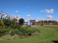 CN train 148 passes through a patriotic setting at Milton, as it passes the provincial flags located at the park where the former CNR station was relocated decades ago. The station started life serving the North & Northwestern RR before CNR assumed control in the 1920s. The line through town was relocated in the 1960s when CN's Toronto yard was relocated to north of Toronto, this forced the line to be upgraded.