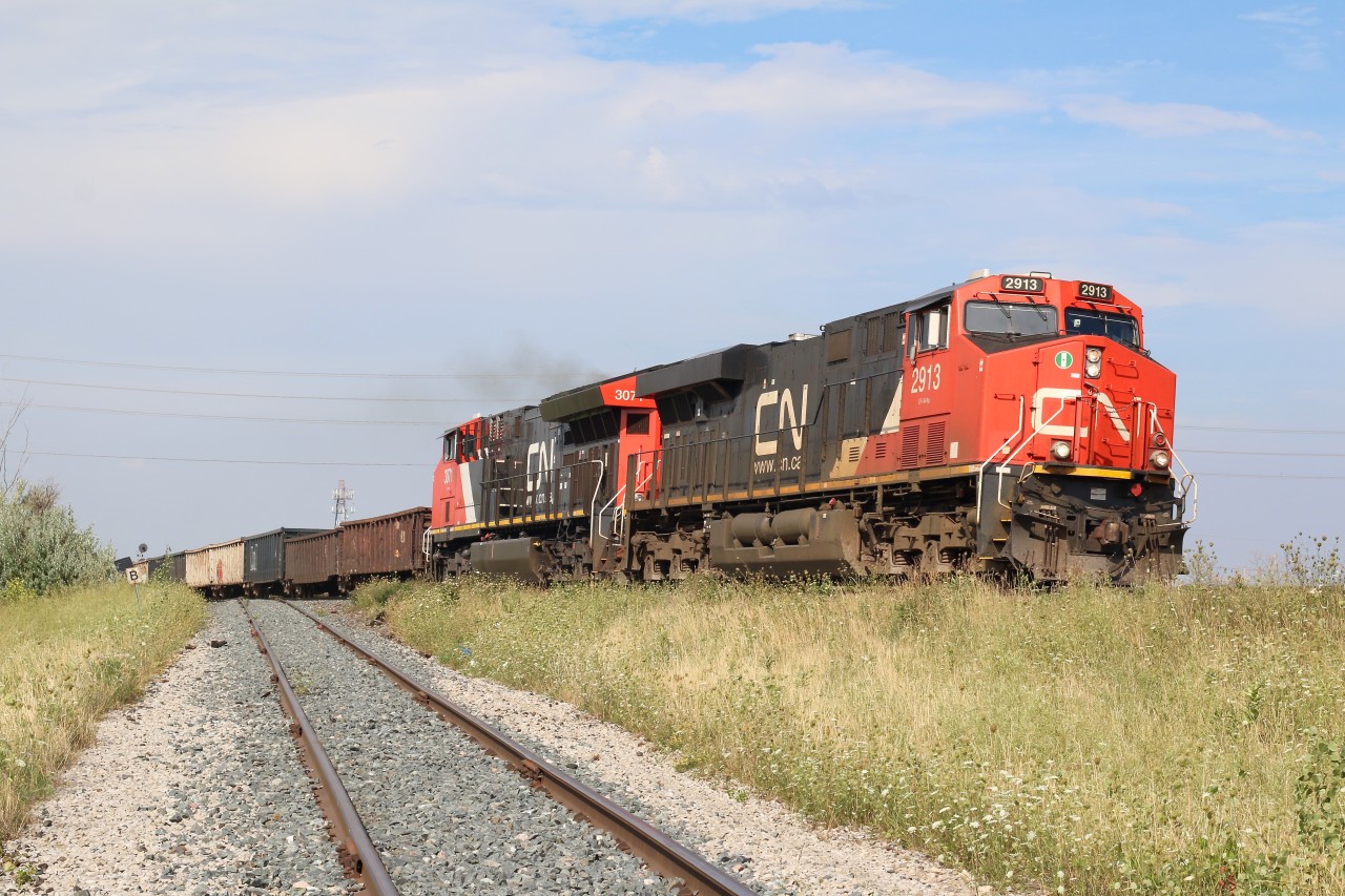 A Tier 3 and a newer Tier 4 GEVO power the days CN train 383 as it rolls past the Glass lead in Milton. The signal in the distance is for the switch at Milbase.
