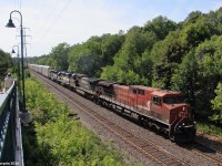 Canadian Pacific train 242 throttles up after the 10mph speed restriction at the Howland Crossover on the final leg of its journey to Toronto Yard with a rainbow consist following behind.